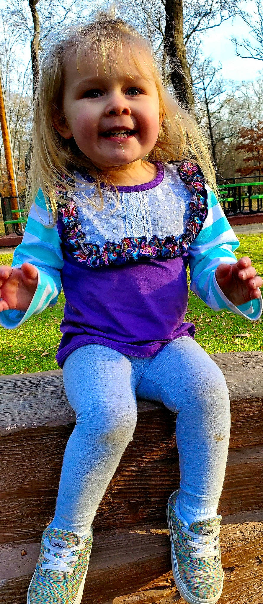 Mckenna is registered to the contest to win money with this photo: blond, child, child_model, denim, electric_blue, fashion_accessory, fun, happy, jeans, joy, leggings, pattern, person, play, playground, recreation, sleeve, smile, swing, textile