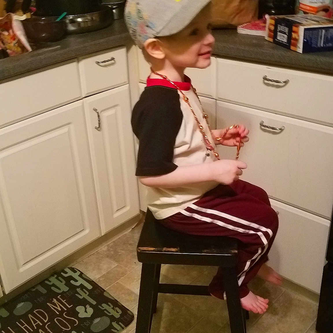 Declan is registered to the contest to win money with this photo: chair, clothing, costume, desk, flooring, furniture, girl, joint, leg, product, shoulder, sitting, table, thigh