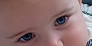 Matthew joined the competition — help win amazing prizes! baby, close_up, face, blue_eyes, chubby_cheeks, infant, cute, lying_down, leaf_pattern, clothing, bed, blanket, indoor, skin, person, portrait, child, young, curious, cute_face