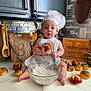 Athena joined the competition — help win amazing prizes! apron, baby, bread, buns, cabinet, chef_hat, child, cooking, countertop, cutting_board, espresso_maker, flour, food, kitchen, oil_bottle, surprised_expression, tile_wall, toddler, utensils, whisk