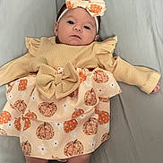 Emerie is registered to the contest to win money with this photo: baby, bed, blackboard, blanket, cap, clothing, cushion, dress, face, furniture, hat, head, homedecor, indoors, newborn, people, person, photography, portrait, sleeping