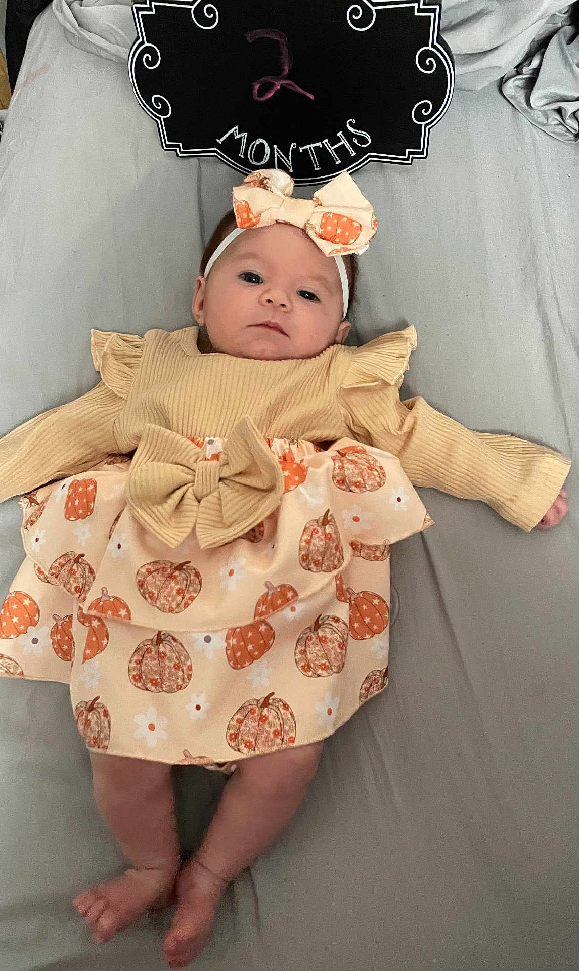 Emerie is registered to the contest to win money with this photo: baby, bed, blackboard, blanket, cap, clothing, cushion, dress, face, furniture, hat, head, homedecor, indoors, newborn, people, person, photography, portrait, sleeping