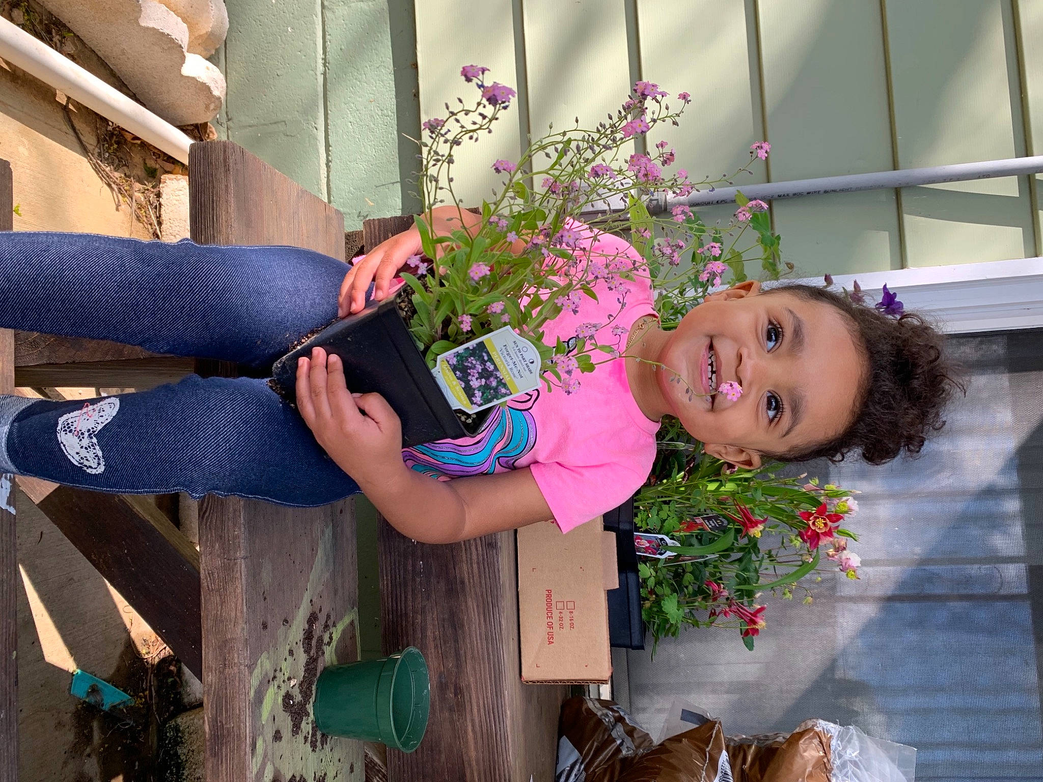Ayla is registered to the contest to win money with this photo: beauty, flower, flowerpot, fun, happy, hat, houseplant, human_leg, joy, leisure, magenta, people, person, photograph, pink, plant, purple, red, smile, snapshot