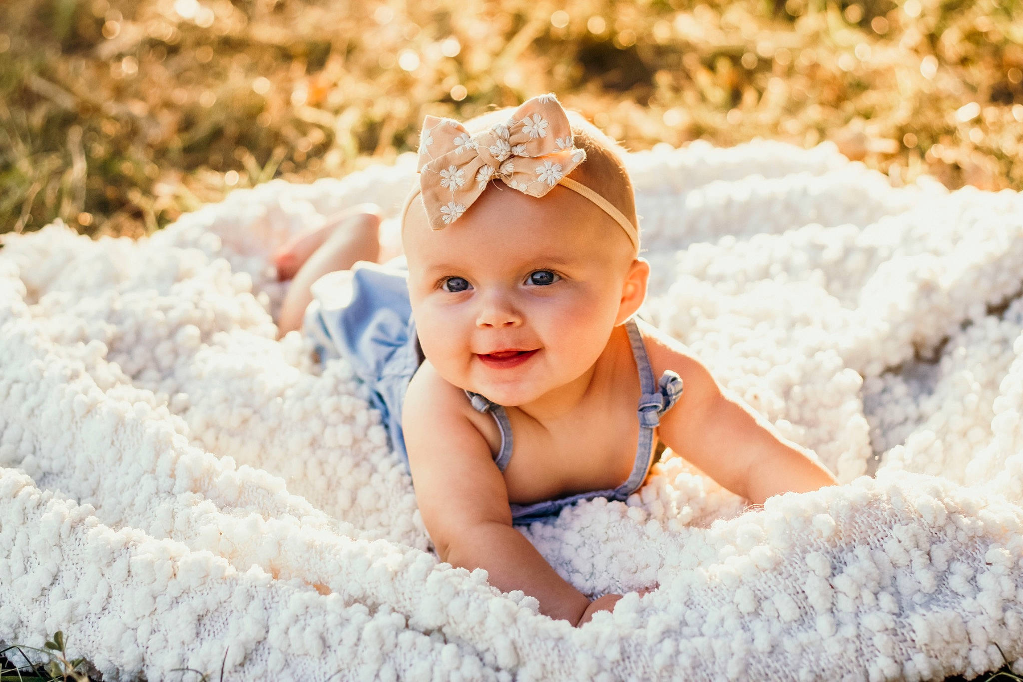 Oaklee is registered to the contest to win money with this photo: baby, baby_toddler_clothing, child, embellishment, face, fashion_accessory, flash_photography, fun, grass, hair_accessory, happy, headband, headpiece, headwear, pattern, people_in_nature, person, portrait_photography, sitting, skin