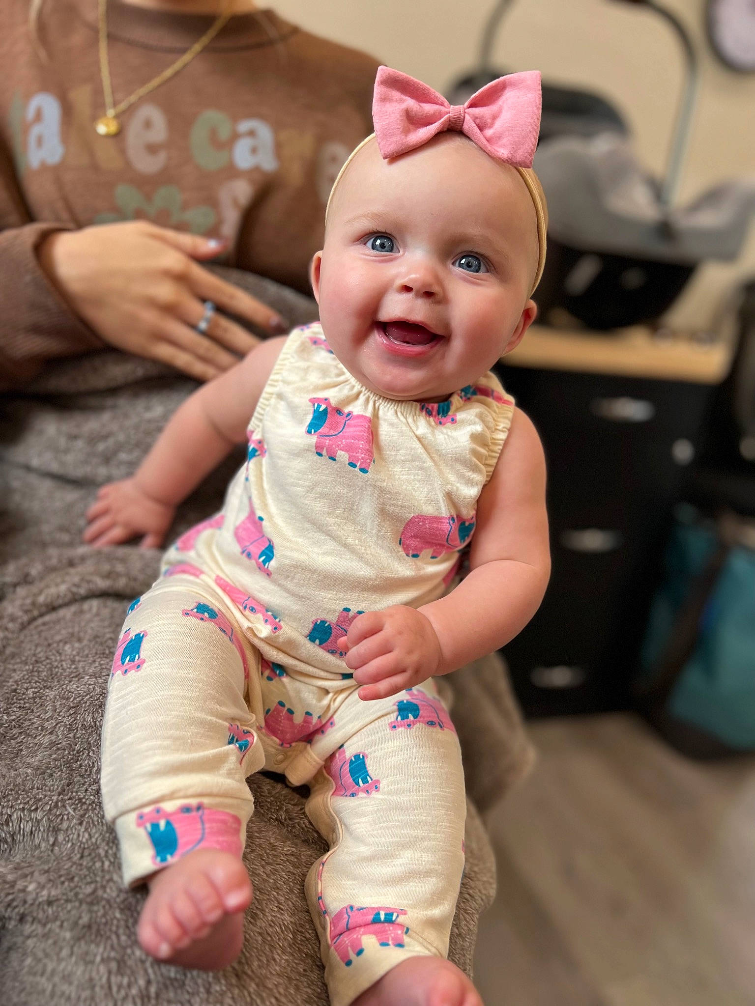 Oaklee is registered to the contest to win money with this photo: baby, baby_toddler_clothing, cheek, child, finger, flooring, foot, fun, happy, human_body, human_leg, joy, person, pink, sitting, skin, sleeve, smile, t_shirt, thigh