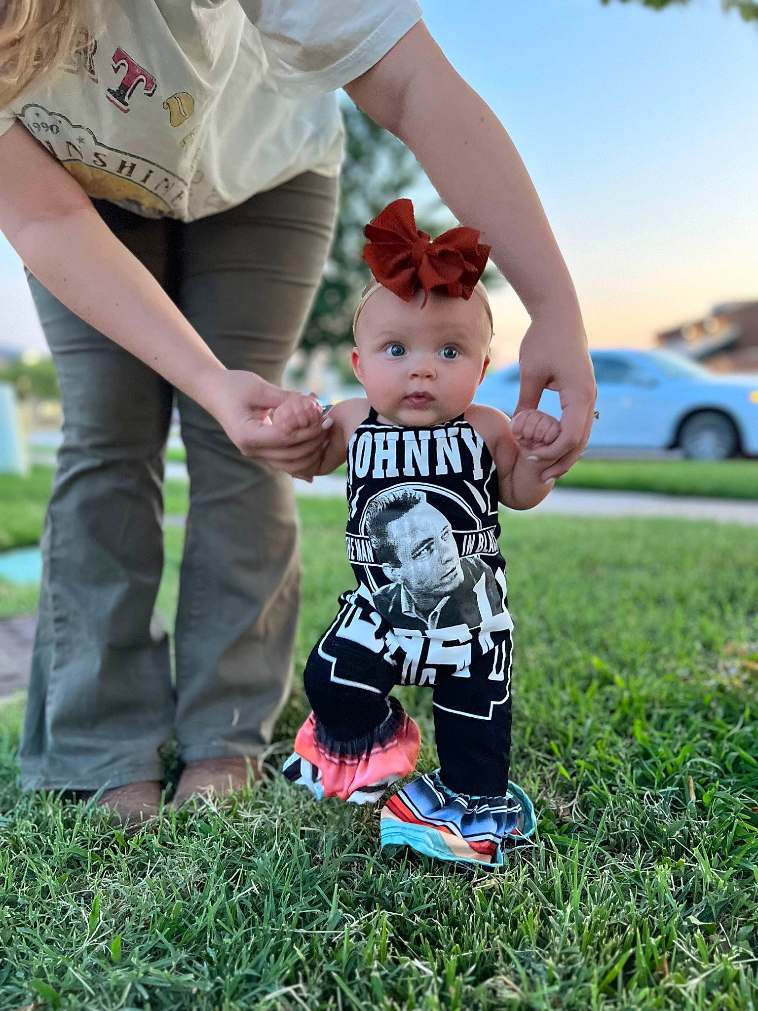 Oaklee is registered to the contest to win money with this photo: baby, baby_toddler_clothing, child, fun, gesture, grass, grass_family, grassland, happy, holding_hands, lawn, leisure, people_in_nature, person, plant, recreation, shorts, sky, summer, surprise