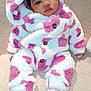 baby, child, infant, onesie, pink, white, fluffy_clothing, socks, sitting, couch, indoor, cute, face, hooded, portrait, warm_clothing, comfortable, cozy, young_child, apparel