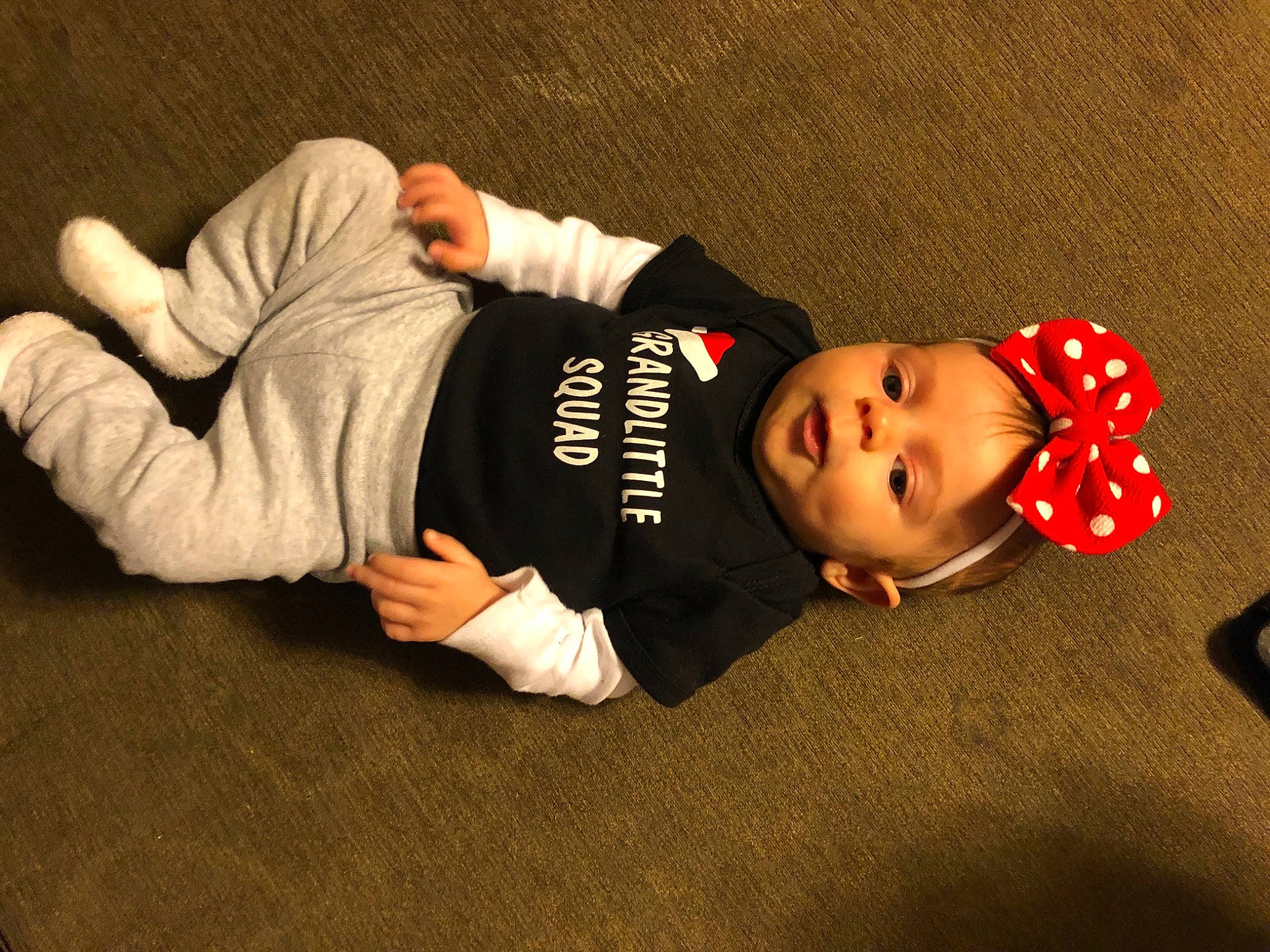 Hadleigh is registered to the contest to win money with this photo: baby, baby_toddler_clothing, carmine, child, comfort, darkness, elbow, flash_photography, flooring, fun, hat, person, photo_shoot, room, sitting, sleeve, sportswear, toddler, wood