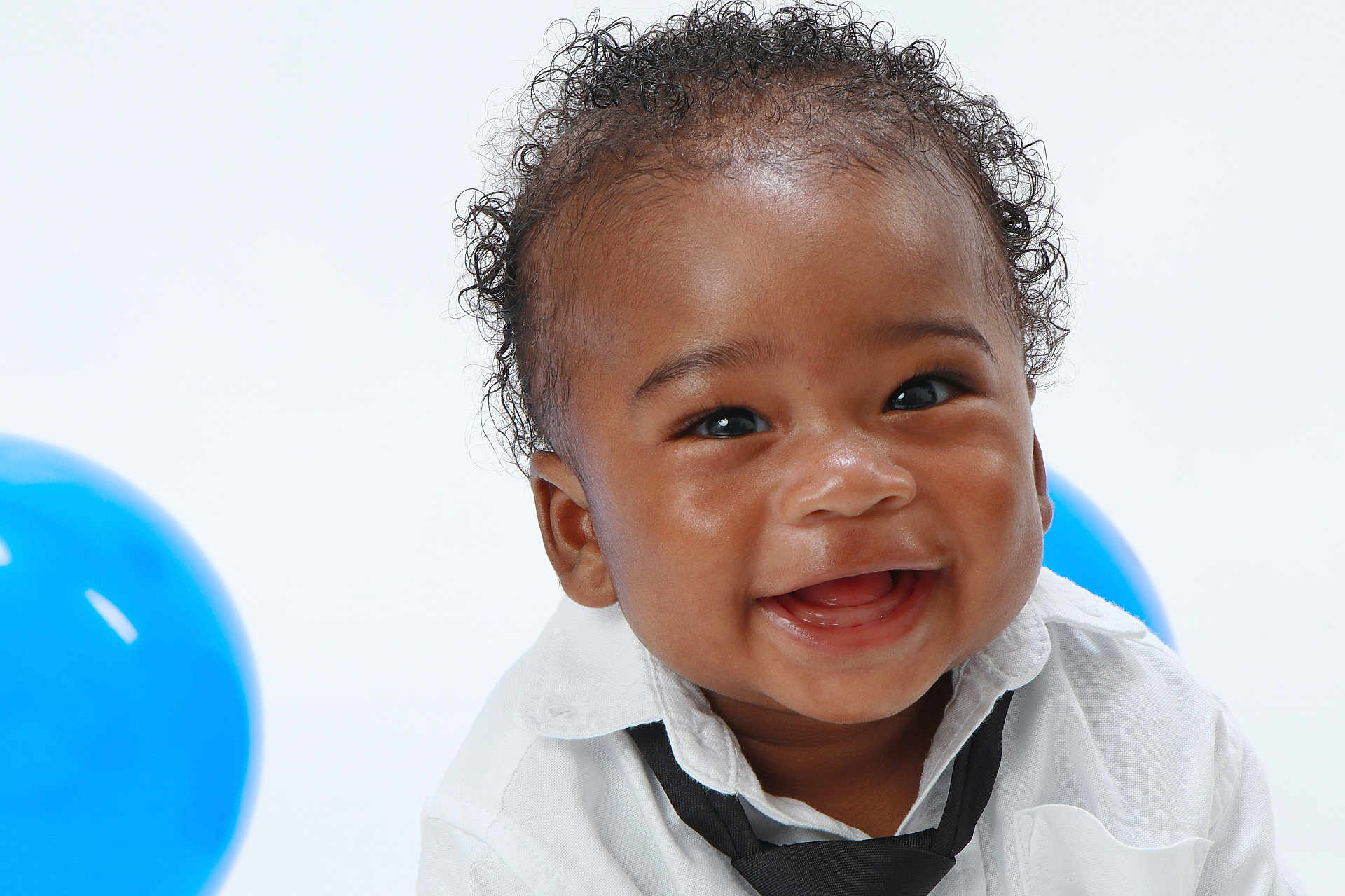 Teo joined the competition — help win amazing prizes! baby, smiling, curly_hair, white_shirt, black_tie, blue_balloon, portrait, happy, cute, child, infant, studio, celebration, closeup, face, joyful, background, person, fun, expression