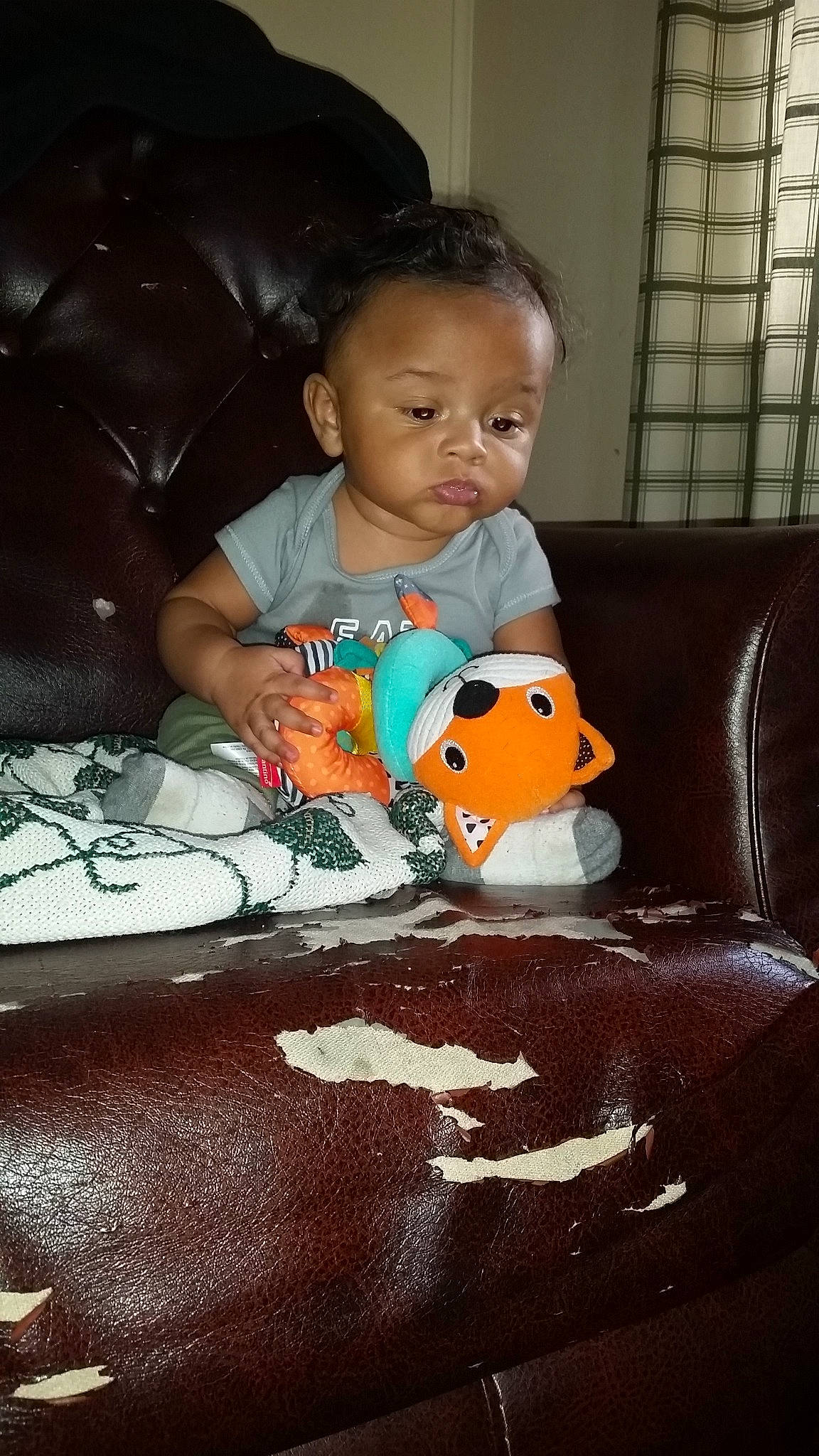 Jared  is registered to the contest to win money with this photo: baby, cheek, child, face, furniture, head, person, play, sitting, skin, toddler, toy