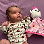 Ivey is registered to the contest to win money with this photo: baby, sleeping, onesie, halloween, pumpkin, ghost, spider, plush_toy, pink, purple, blanket, infant, cute, soft, toy, child, sleep, peaceful, clothing, indoor