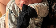 Leonidas is registered to the contest to win money with this photo: baby, infant, child, face, hat, mittens, clothing, person, cute, closeup, newborn, apparel, fabric, skin, hand, soft, indoor, portrait, holding, babywear