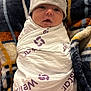 Leonidas joined the competition — help win amazing prizes! baby, infant, swaddle, hat, blanket, pattern, face, mouth_open, soft, cute, newborn, wrapped, cozy, child, sleepwear, bed, comfort, warm, indoor, portrait