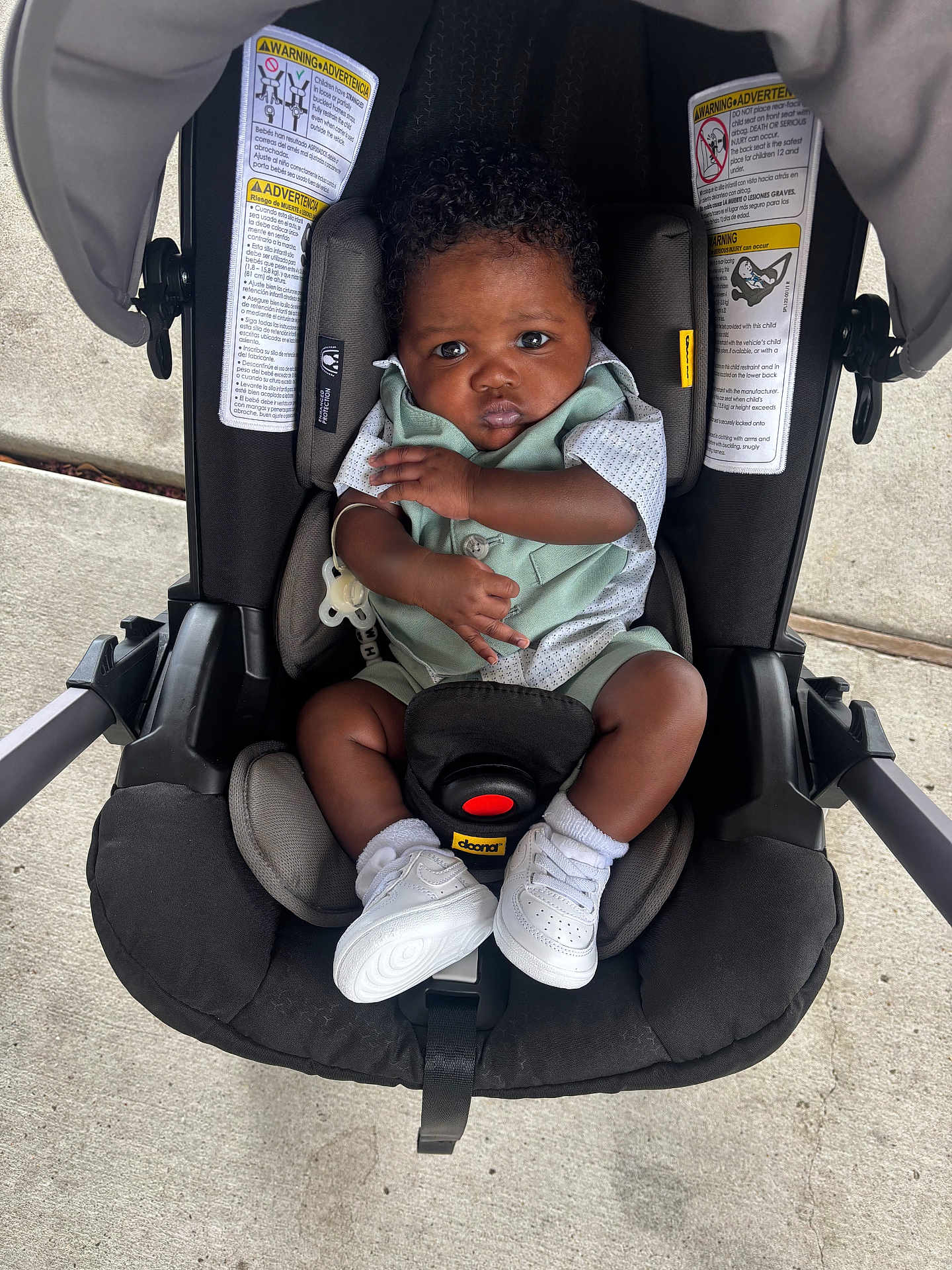Kashmir joined the competition — help win amazing prizes! baby, infant, car_seat, child, white_sneakers, mint_green_outfit, curly_hair, sitting, strapped_in, outdoor, concrete, cute, secure, serious_expression, footwear, clothing, infant_baby, seat, young_child, portrait