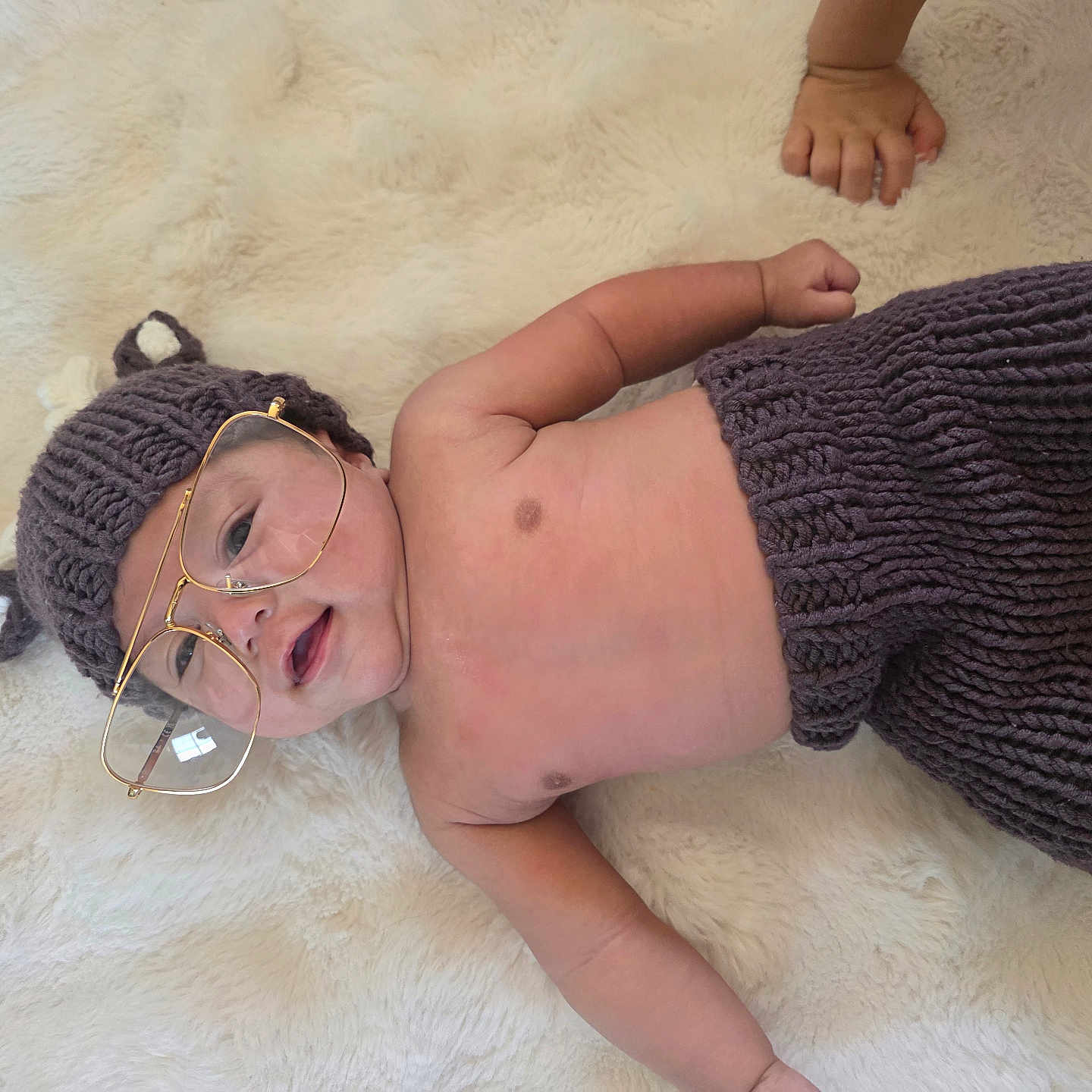 Alexander Jay joined the competition — help win amazing prizes! baby, baby_clothing, bear_ears, blanket, child, cozy, cute, face, fashion, glasses, hand, headwear, indoors, infant, knitted_hat, lying_down, portrait, smiling, soft_texture, warm