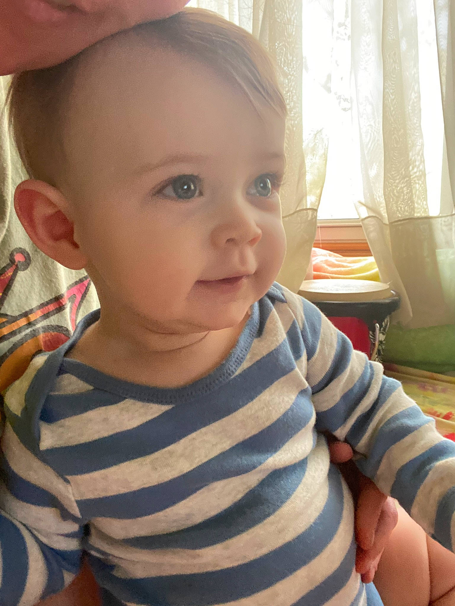 Solomon is registered to the contest to win money with this photo: baby_toddler_clothing, cheek, chin, curtain, ear, eye, eyebrow, facial_expression, forehead, iris, joint, lip, mouth, neck, nose, person, shoulder, skin, sleeve, smile