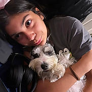 Rocket San Miguel joined the competition — help win amazing prizes! person, dog, hugging, closeup, indoor, headphones, cuddling, face, pet, friendship, comfort, relaxation, casual_clothing, black_hair, curly_fur, expressive_eyes, home, affection, resting, portrait