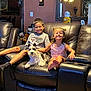 Rocket San Miguel joined the competition — help win amazing prizes! child, smiling, dog, schnauzer, leather_couch, living_room, mirror, ceiling_fan, cross, wall, floor_tiles, shorts, tshirt, barefoot, happy, home_interior, family, furniture, indoor, portrait