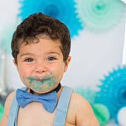 Estéban participe au concours pour gagner de l'argent avec cette photo : toddler, child, face_paint, blue_bow_tie, suspenders, cake_smear, smile, happy, portrait, celebration, party_decor, indoor, cute, messy, brown_hair, young_child, fun, festive, background_blur, person