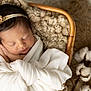 newborn, baby, sleeping, blanket, headband, flower, basket, cotton, soft_texture, wrapped, peaceful, infant, closeup, indoor, cute, portrait, resting, cozy, delicate, natural