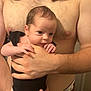 Athena joined the competition — help win amazing prizes! baby, infant, adult, shirtless, holding, black_clothing, long_hair, hand, arm, skin, person, indoor, family, parent, newborn, caring, human, closeup, expression, portrait