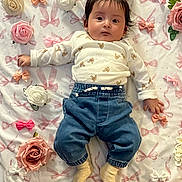 Jenny joined the competition — help win amazing prizes! baby, infant, child, face, clothing, shirt, pants, denim, socks, flowers, roses, bows, blanket, pattern, cute, lying, indoors, decorative, soft, portrait