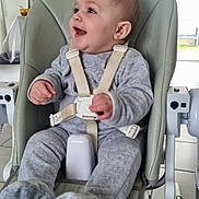 Lyvia participe au concours pour gagner de l'argent avec cette photo : baby, high_chair, gray_pajamas, smiling, indoor, child, seatbelt, furniture, happy, person, floor_tiles, modern_kitchen, baby_clothes, infant, cute, child_seat, sitting, baby_face, playful, home