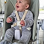 baby, high_chair, gray_pajamas, smiling, indoor, child, seatbelt, furniture, happy, person, floor_tiles, modern_kitchen, baby_clothes, infant, cute, child_seat, sitting, baby_face, playful, home
