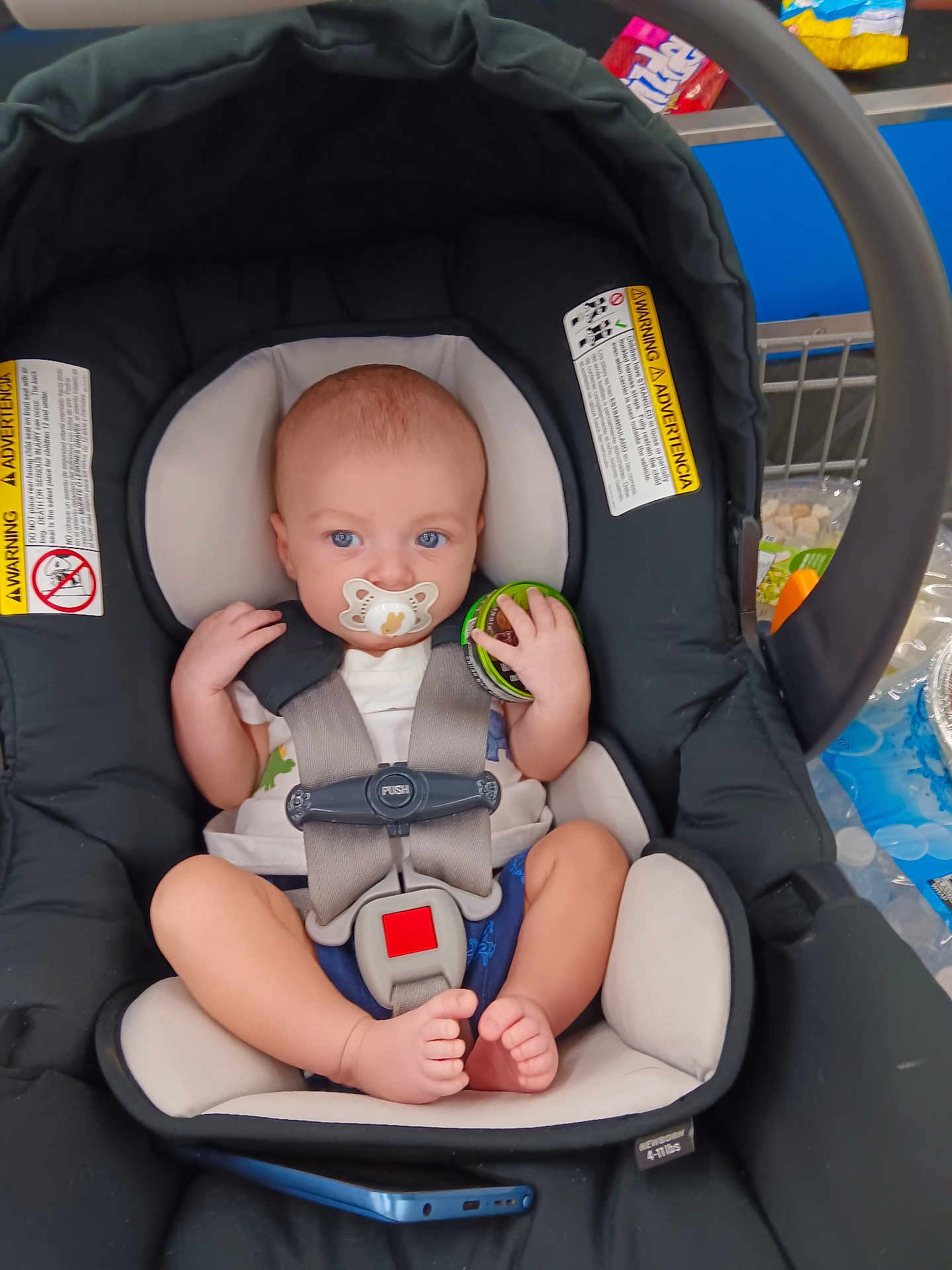Jason John Henry joined the competition — help win amazing prizes! baby, blue_eyes, car_seat, child, clothing, container, foot, footwear, grocery, hand, holding, infant, pacifier, plastic, retail, seat, shopping, shopping_cart, sitting, straps