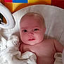 baby, blanket, stuffed_animal, colorful_background, infant, soft_toy, child, portrait, cute, young, indoors, resting, white, comfort, smile, face, skin, lying_down, toy, warm