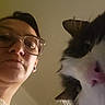 Bobby participe au concours pour gagner de l'argent avec cette photo : woman, person, cat, black_and_white_cat, pet, selfie, portrait, glasses, eyeglasses, face, whiskers, fur, fluffy, indoor, close_up, vertical_photo, companion, human, animal, home