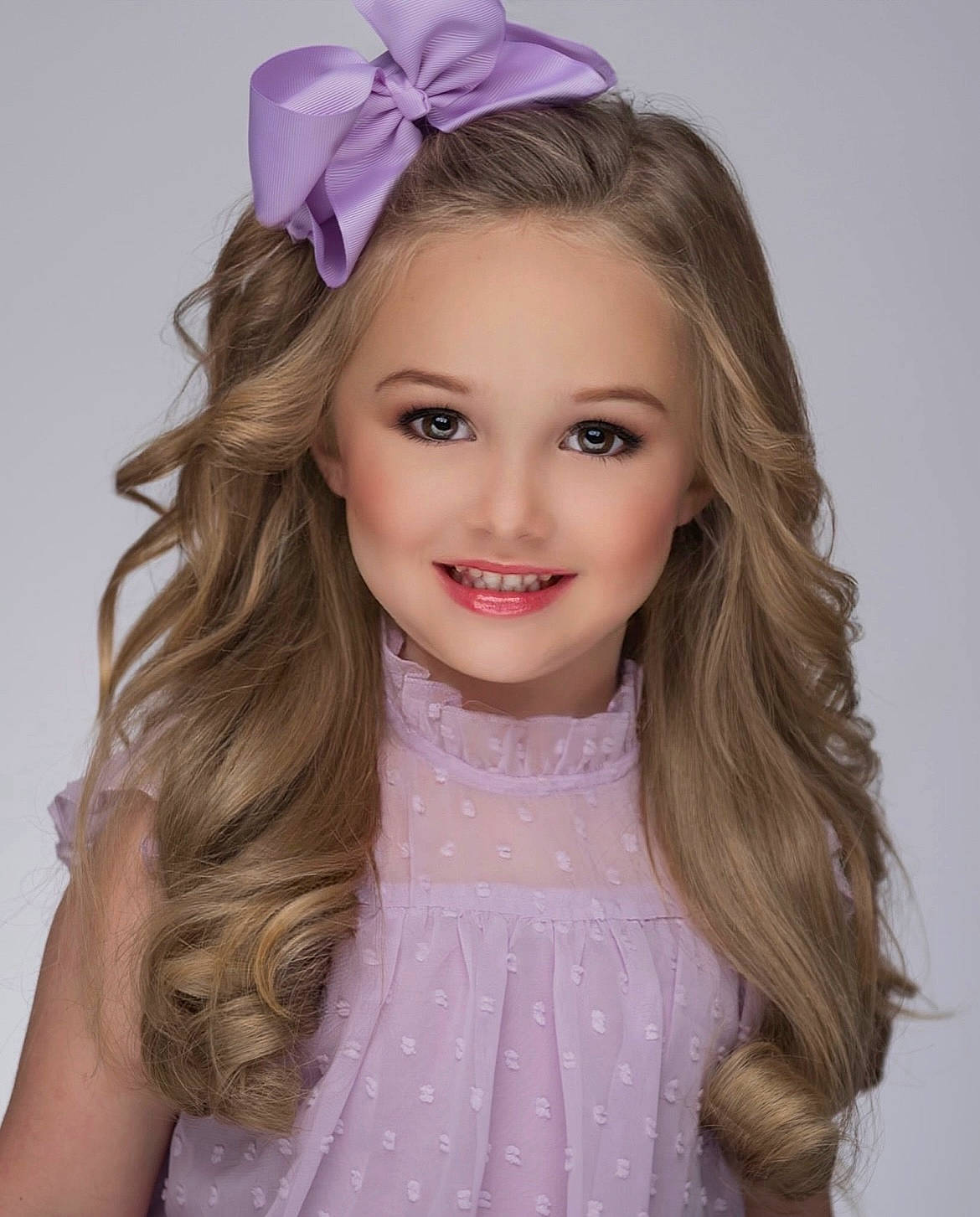 Kentleigh is registered to the contest to win money with this photo: chin, dress, embellishment, eye, eyebrow, eyelash, flash_photography, hair, happy, head, iris, joy, lip, makeover, neck, person, pink, purple, shoulder, smile