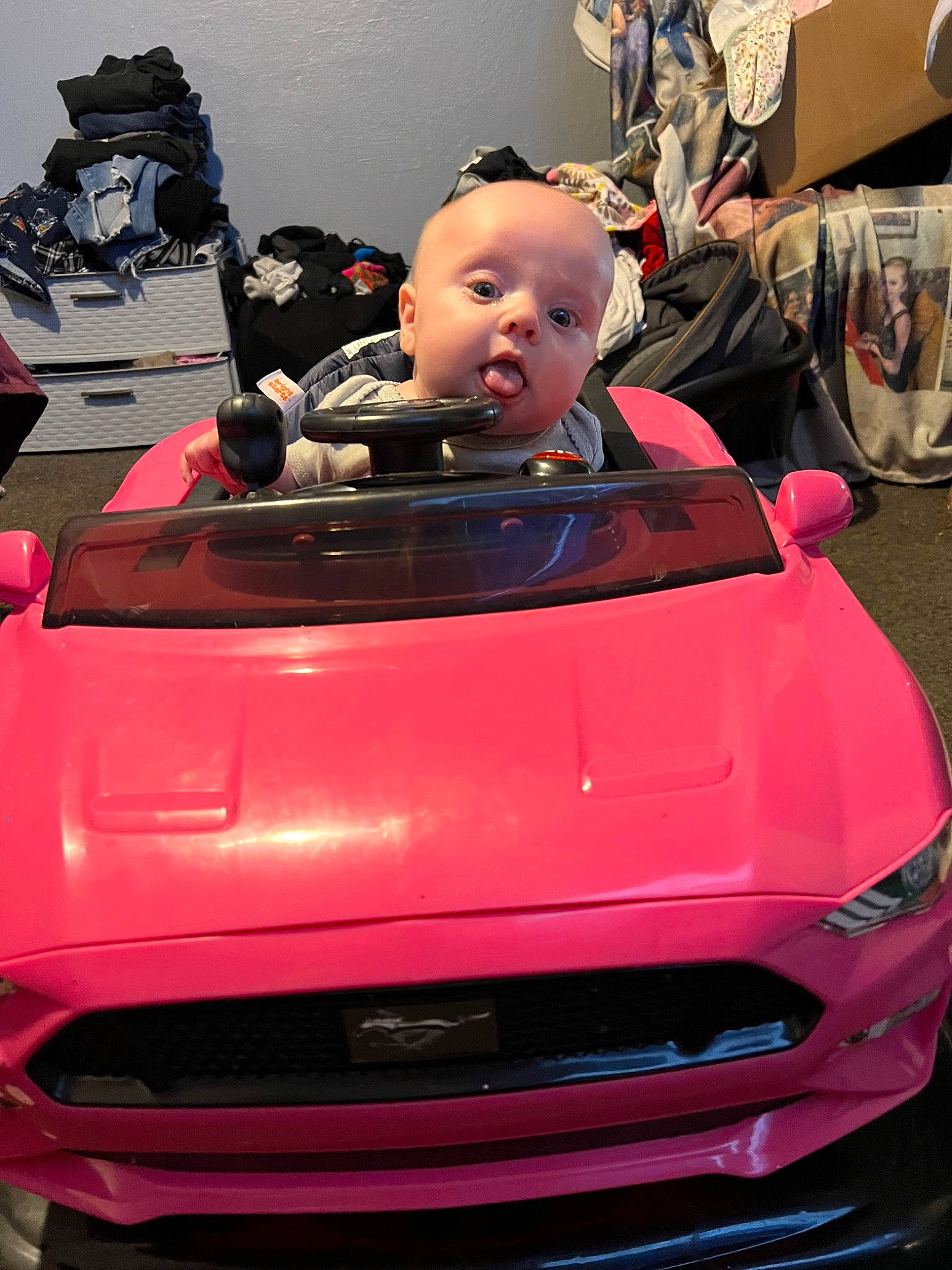 Aurora is registered to the contest to win money with this photo: auto_part, automotive_design, automotive_exterior, automotive_lighting, automotive_tire, automotive_wheel_system, bumper, car, grille, headlamp, hood, motor_vehicle, person, personal_luxury_car, pink, red, surprise, tints_and_shades, toy, vehicle