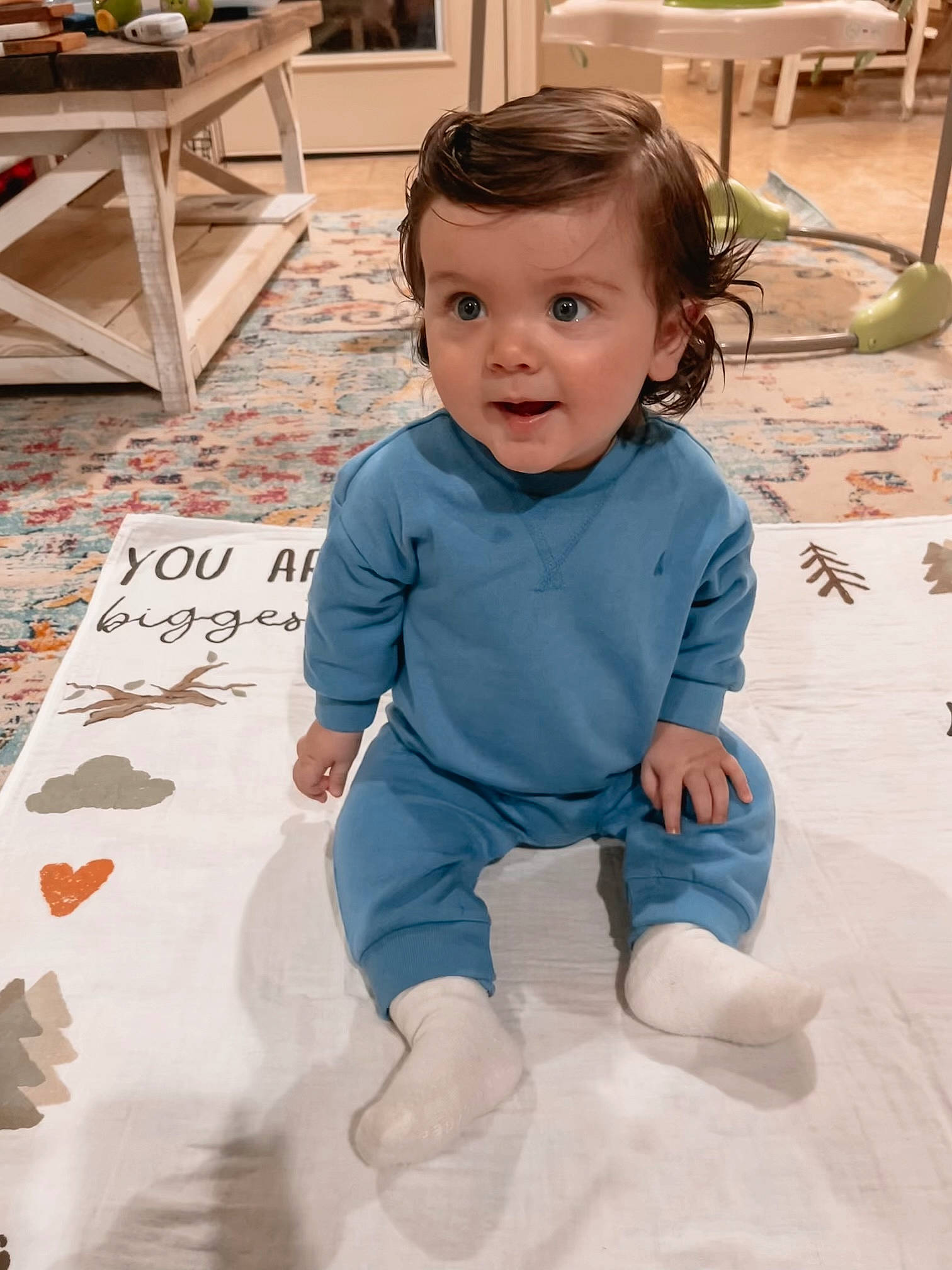 Bennett is registered to the contest to win money with this photo: baby, baby_toddler_clothing, chair, cheek, child, floor, flooring, fun, happy, hardwood, head, houseplant, knee, person, room, skin, sleeve, smile, t_shirt, toddler