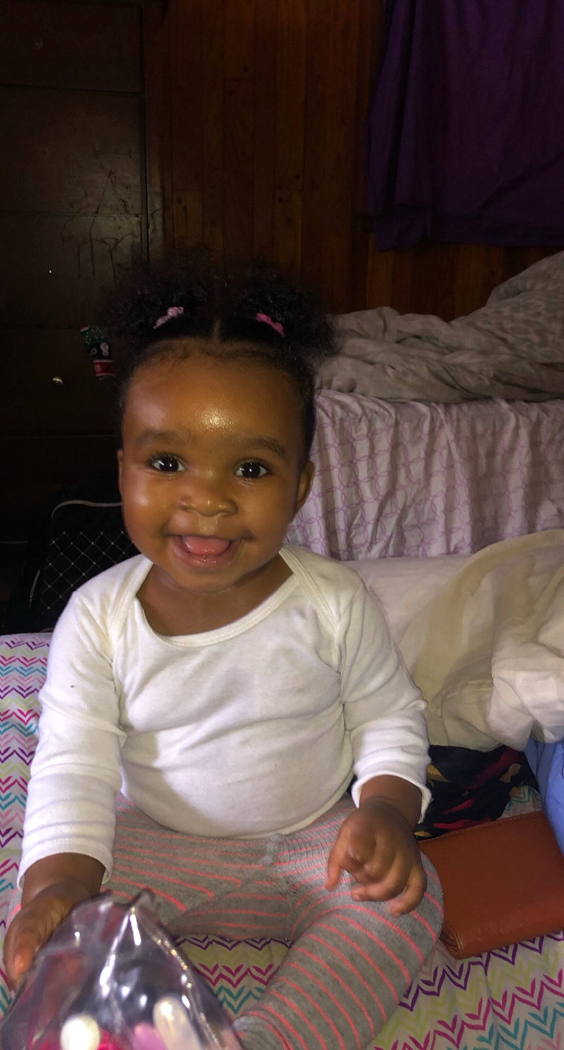 Araya is registered to the contest to win money with this photo: baby, baby_toddler_clothing, cheek, child, comfort, cool, ear, joy, lap, linens, living_room, nose, person, pillow, sitting, sock, toddler