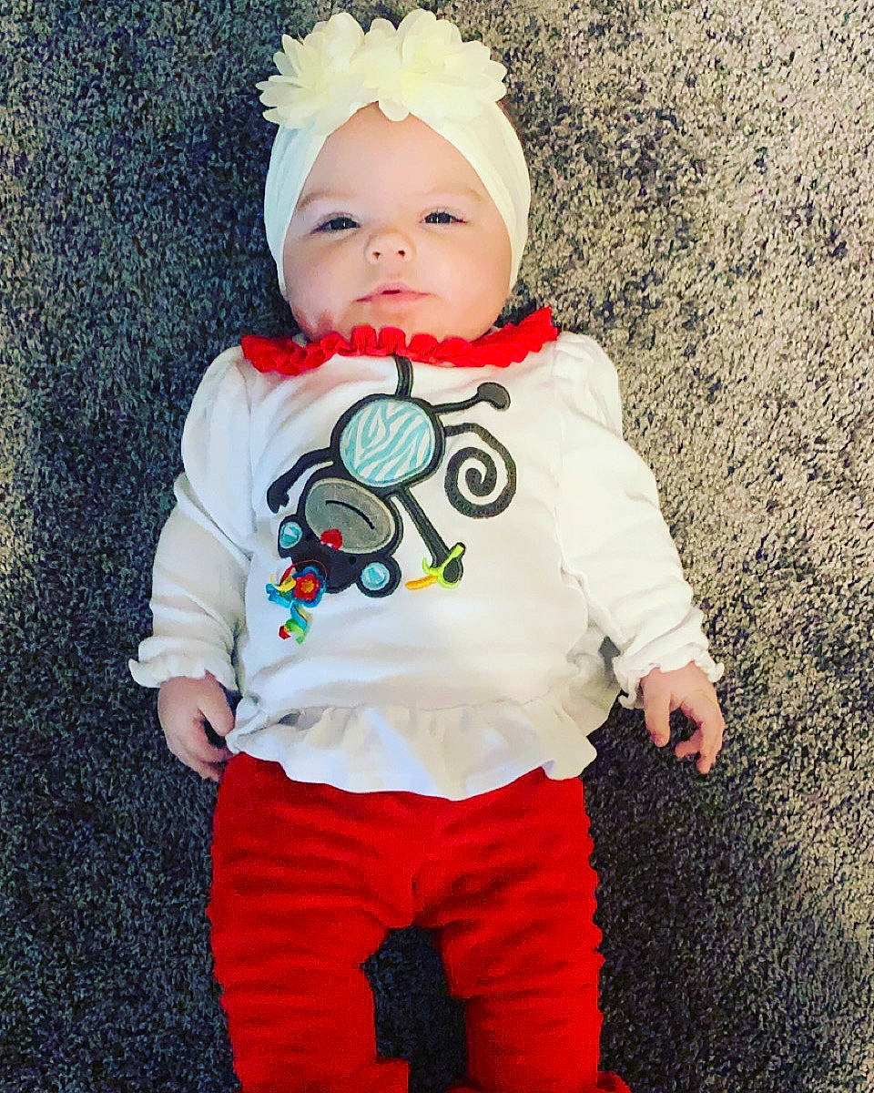 Kyrie is registered to the contest to win money with this photo: baby, baby_toddler_clothing, carmine, child, costume, costume_accessory, costume_hat, fictional_character, font, fun, happy, head, headgear, headwear, long_sleeved_t_shirt, pattern, person, personal_protective_equipment, sleeve, smile