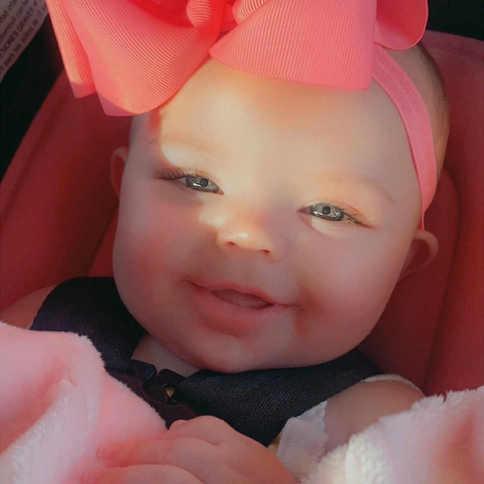 Kyrie joined the competition — help win amazing prizes! baby, cap, child, dress, eyebrow, finger, fun, gesture, hand, happy, headgear, human, lip, petal, pink, product, skin, smile, thumb, toddler