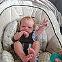 baby, baby_seat, child, closeup, clothing, comfort, cushion, cute, foot, hand, indoor, infant, newborn, pacifier, person, reaching_hand, relaxing, sitting, soft_lighting, straps