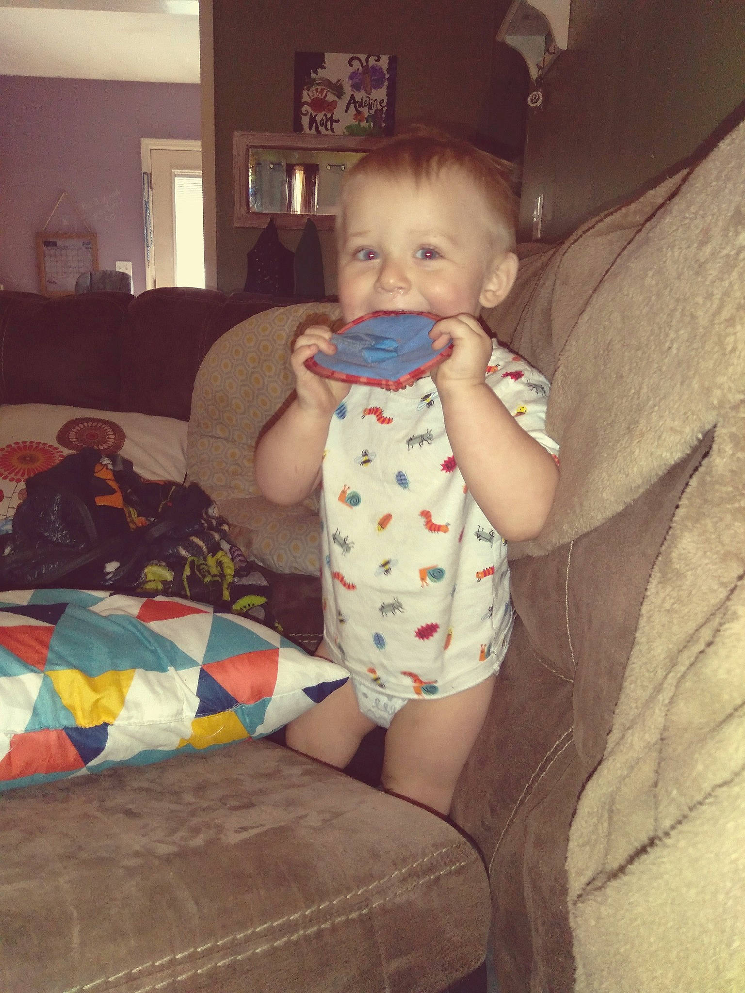 Kolt is registered to the contest to win money with this photo: baby, baby_toddler_clothing, child, comfort, couch, elbow, finger, happy, human_leg, knee, lap, person, picture_frame, room, shoulder, sitting, skin, textile, thigh, toddler