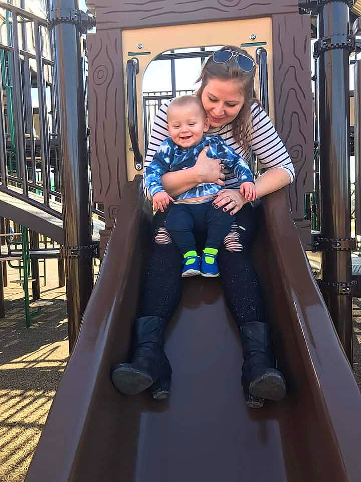 Kolt is registered to the contest to win money with this photo: baby, baby_products, baby_toddler_clothing, child, city, dress, electric_blue, face, fun, handrail, happy, joy, leisure, outdoor_play_equipment, person, playground, public_space, recreation, sitting, smile