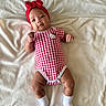 Kamila is registered to the contest to win money with this photo: baby, infant, red_headband, hello_kitty, onesie, white_socks, blanket, soft_texture, lying_down, cute, smiling, indoors, child, portrait, human, clothing, headwear, baby_girl, comfortable, resting