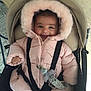 Giulia a rejoint le concours — aidez-le/la à gagner de superbes lots ! baby, child, smiling, pink_coat, hood, car_seat, seatbelt, straps, indoor, flooring, happy, cute, clothing, person, infant, face, bundle, warm, comfort, safety