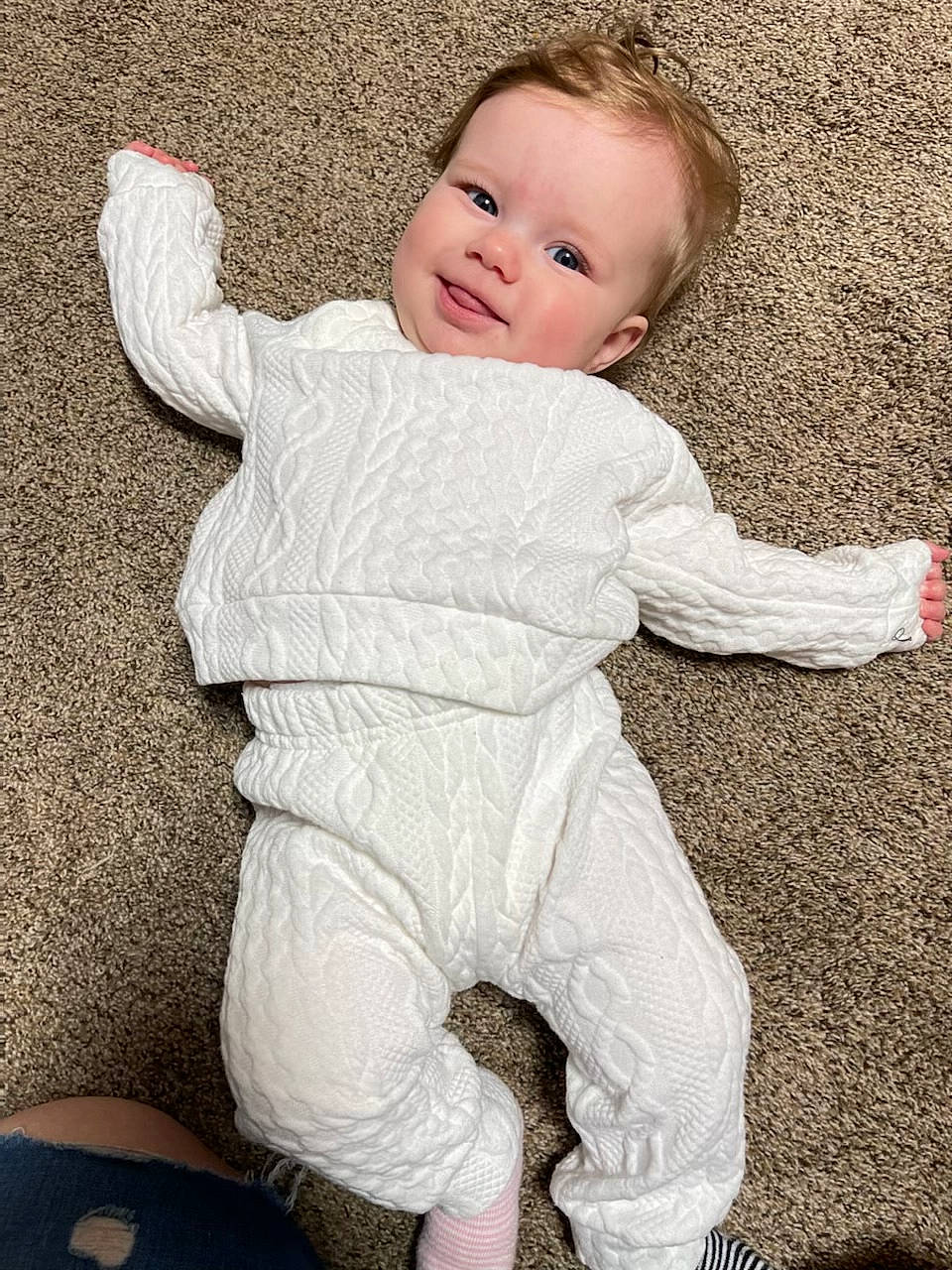 Kailani is registered to the contest to win money with this photo: baby, baby_toddler_clothing, child, comfort, face, flooring, fur, gesture, happy, head, human_body, joy, pattern, people_in_nature, person, sitting, skin, sleeve, smile, t_shirt