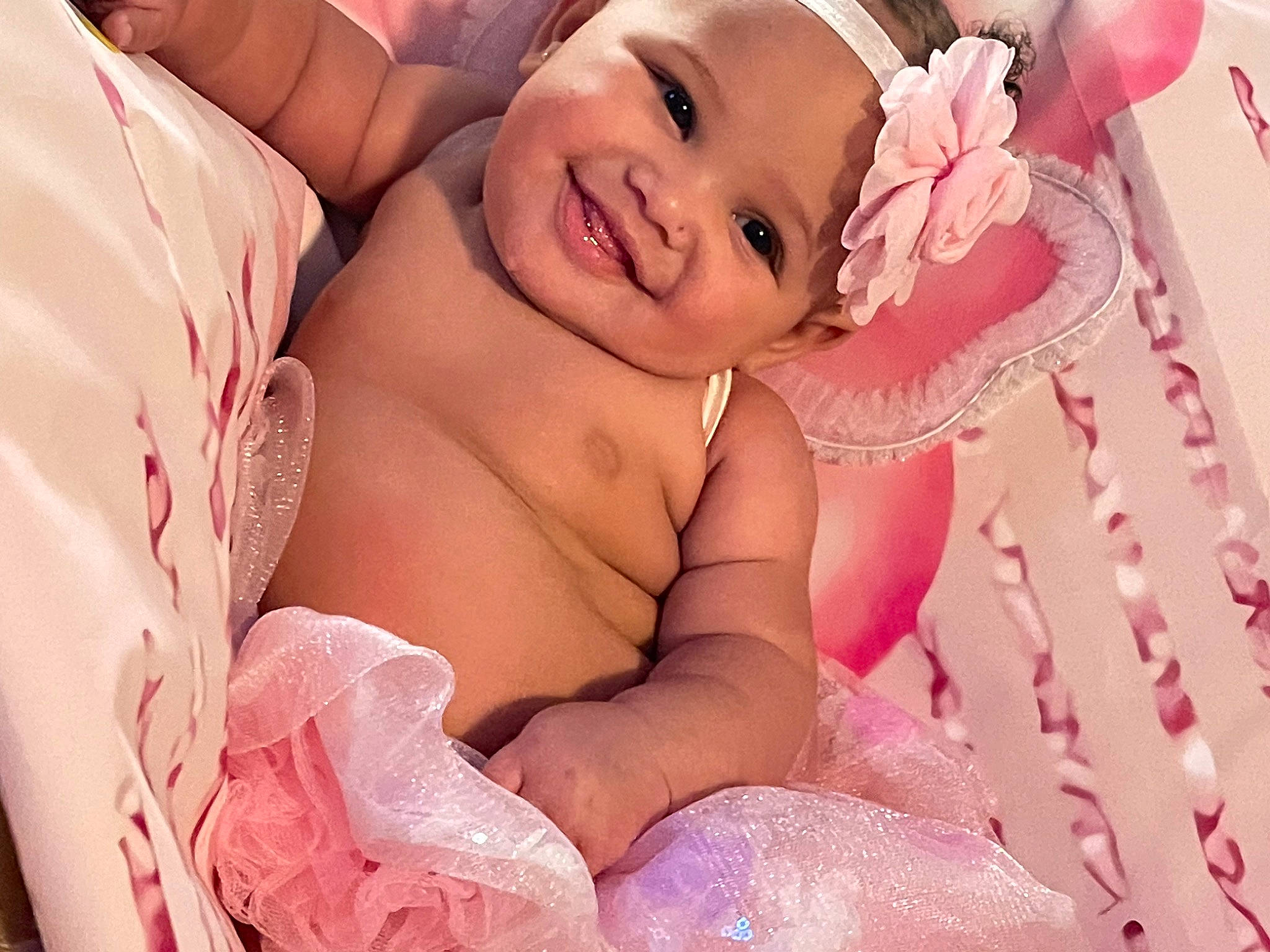 Ranya joined the competition — help win amazing prizes! baby, baby_toddler_clothing, child, comfort, event, finger, flash_photography, fun, gesture, happy, headgear, headpiece, headwear, joy, linens, magenta, peach, person, petal, pink