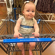 Lorraine joined the competition — help win amazing prizes! baby, shopping_cart, child, store, retail, clothing, rack, floor, bow, girl, barefoot, walmart, curious, shopping, aisle, infant, seated, handle, expression, casual