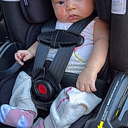 Angela joined the competition — help win amazing prizes! baby, black, bow, car_seat, child, clothing, cute, expression, face, footwear, hand, headband, indoors, infant, person, pink, safety, seatbelt, socks, white