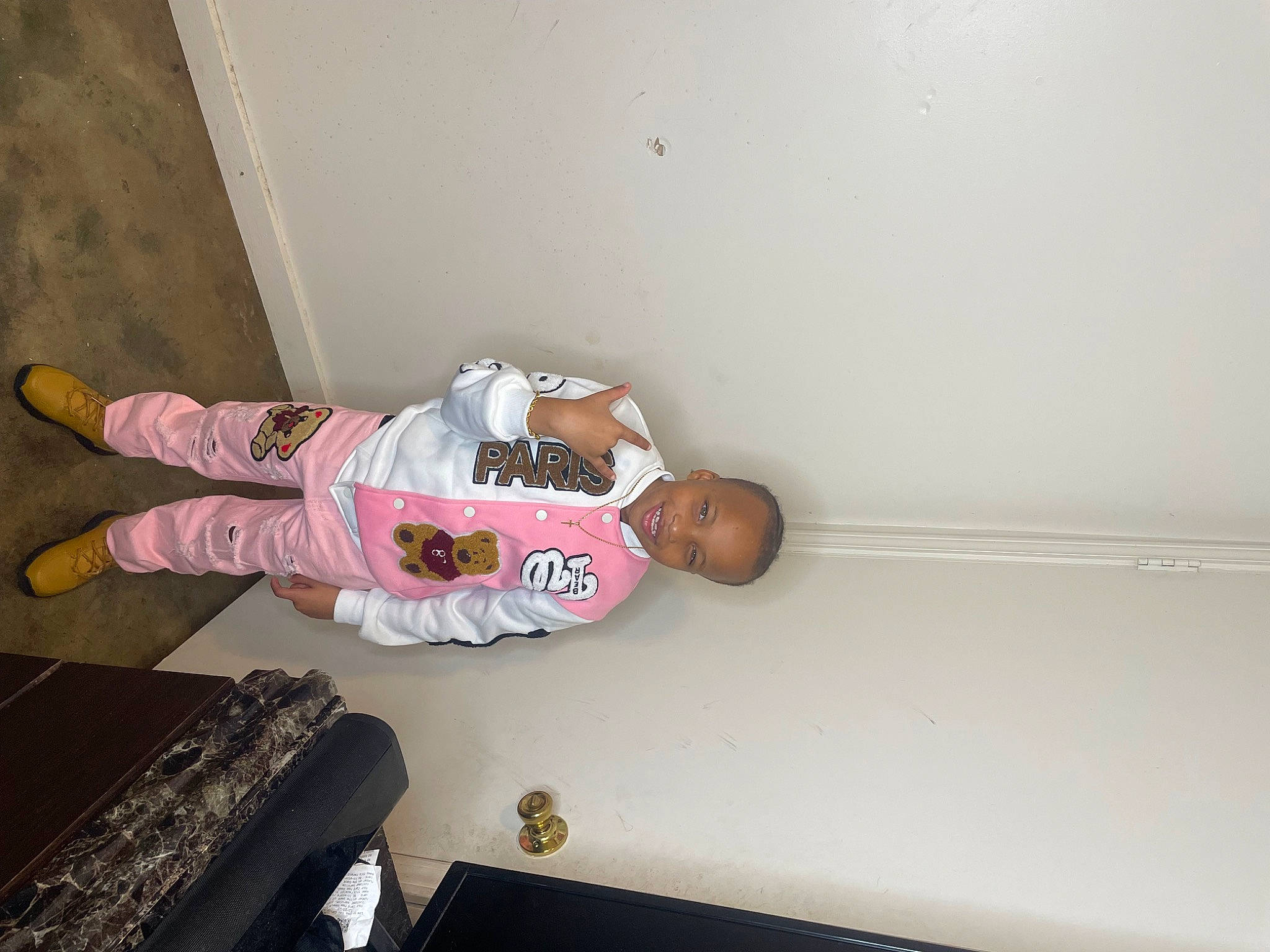 Zayden joined the competition — help win amazing prizes! baby_toddler_clothing, ceiling, child, comfort, elbow, flooring, fun, hardwood, human_leg, joy, knee, outdoor_shoe, person, room, sitting, sleeve, sock, t_shirt, thigh, toddler