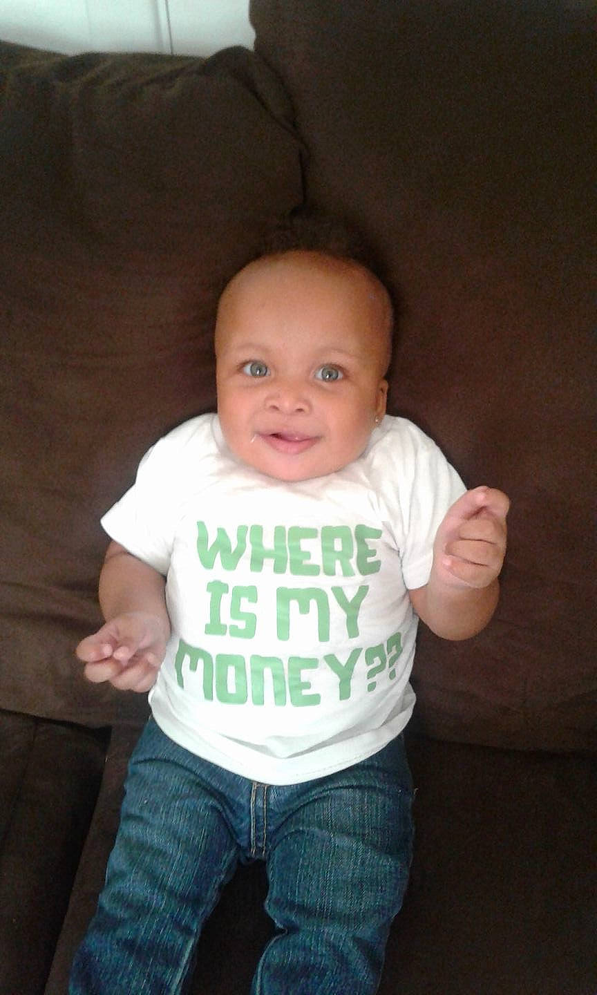 Zayden is registered to the contest to win money with this photo: arm, baby, baby_toddler_clothing, cheek, child, eye, happy, head, iris, jeans, nose, organ, person, skin, sleeve, smile, standing, stomach, t_shirt, toddler