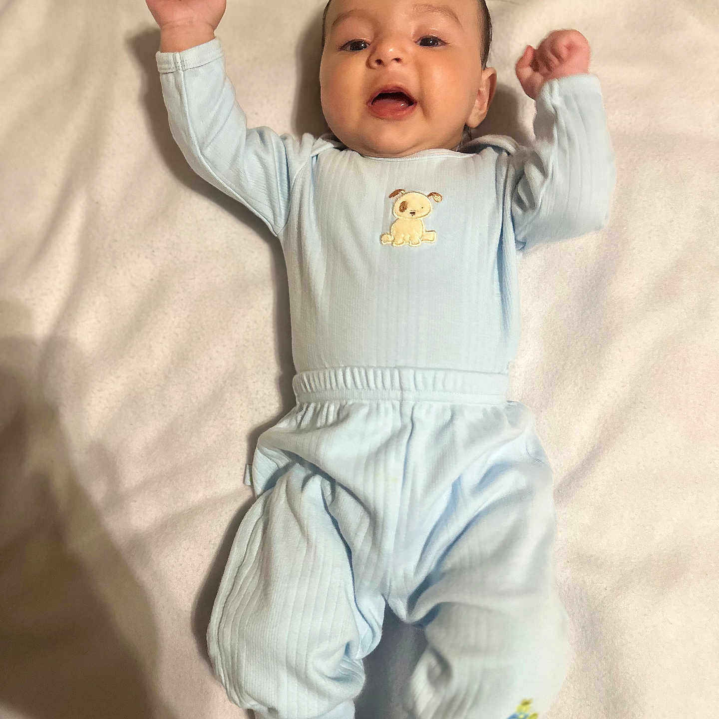 Lane joined the competition — help win amazing prizes! baby, blanket, blue_clothing, child, comfort, cozy, cute, face, happy, indoors, infant, lying_down, pajamas, portrait, raised_arms, shadow, sleepwear, smiling, soft_texture, young_child