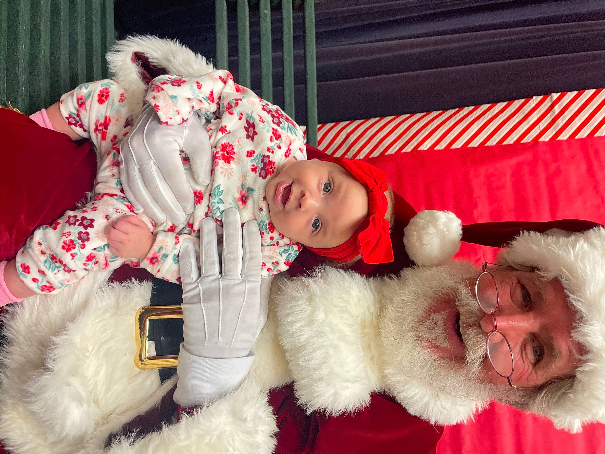 Justyce is registered to the contest to win money with this photo: baby_toddler_clothing, child, christmas, christmas_eve, companion_dog, costume, event, facial_expression, fur, fur_clothing, happy, hat, headwear, holiday, lap, person, pink, red, santa_claus, textile